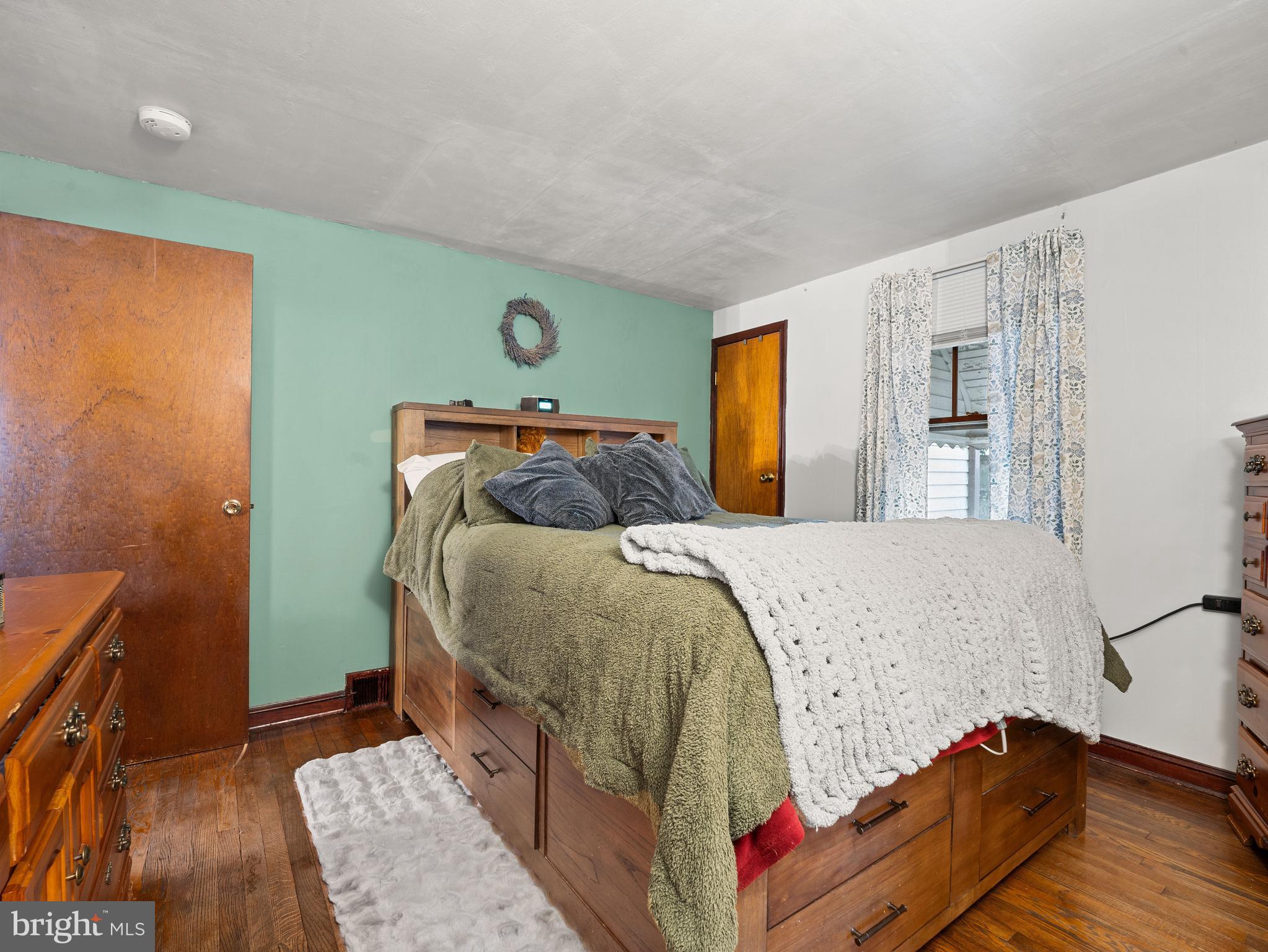 102 Queen Anne Road Glen Burnie, MD 21060 - Photo 11 of 26 a bedroom with a bed and wooden floor