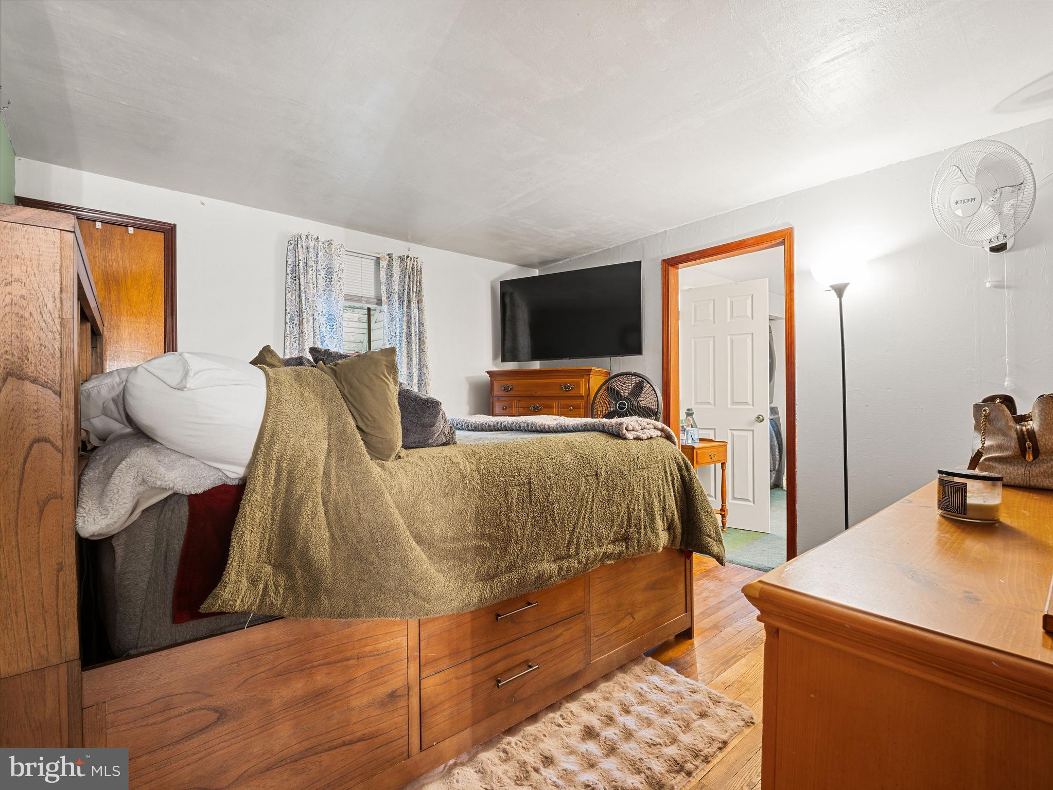 102 Queen Anne Road Glen Burnie, MD 21060 - Photo 12 of 26 a bedroom with a bed and wooden floor