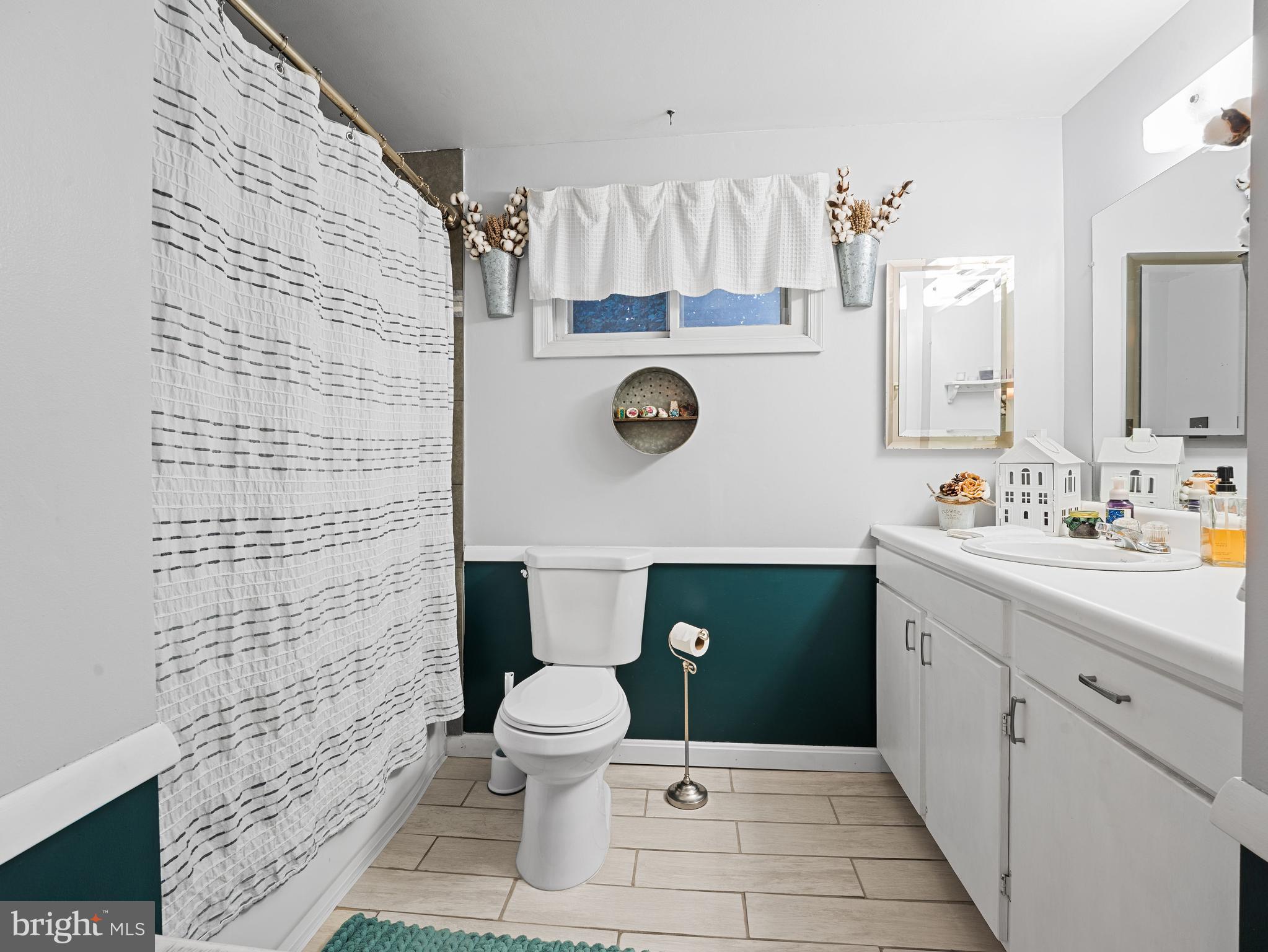 102 Queen Anne Road Glen Burnie, MD 21060 - Photo 16 of 26 a bathroom with a toilet sink and mirror