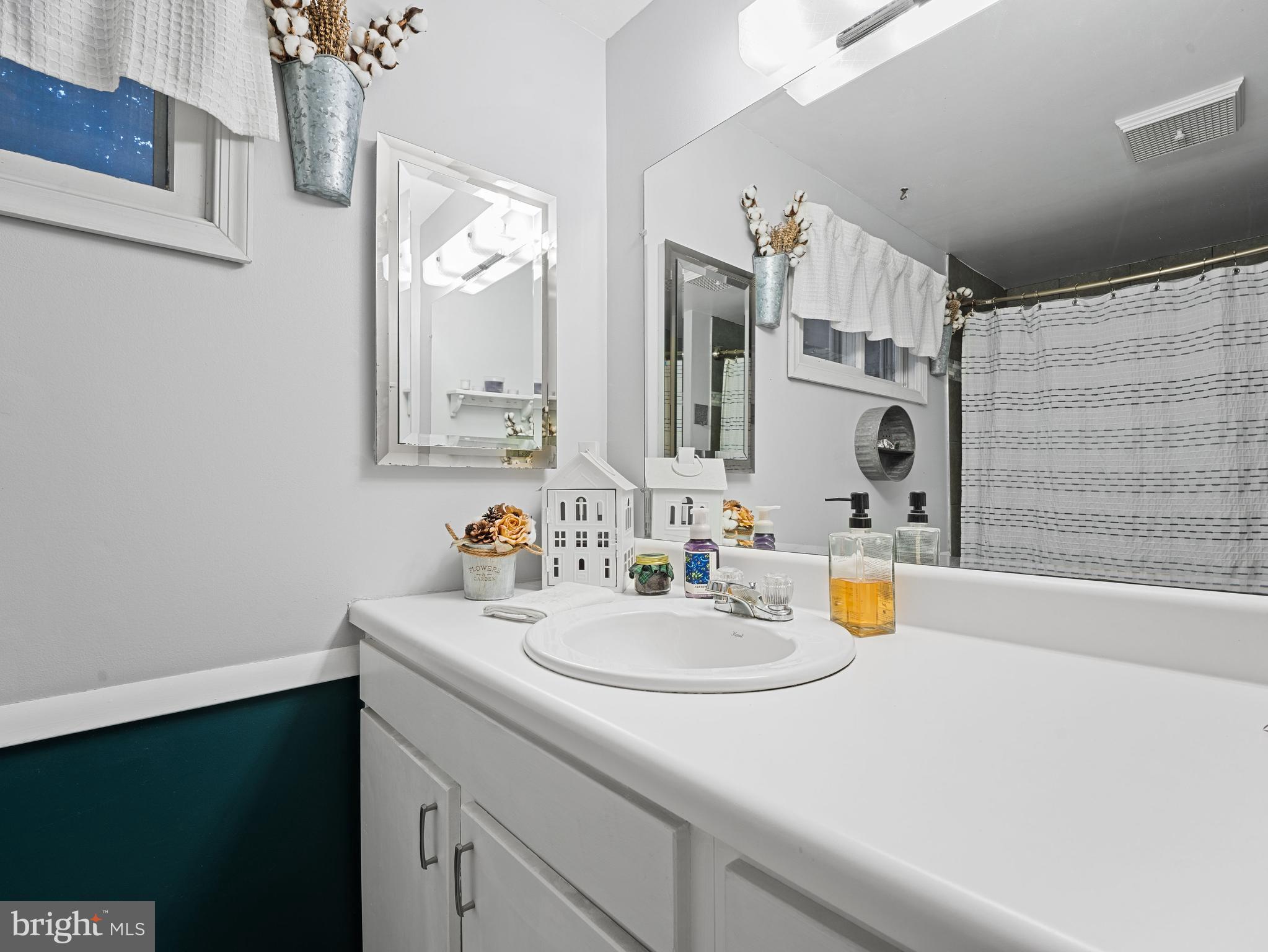 102 Queen Anne Road Glen Burnie, MD 21060 - Photo 17 of 26 a bathroom with a sink and a mirror