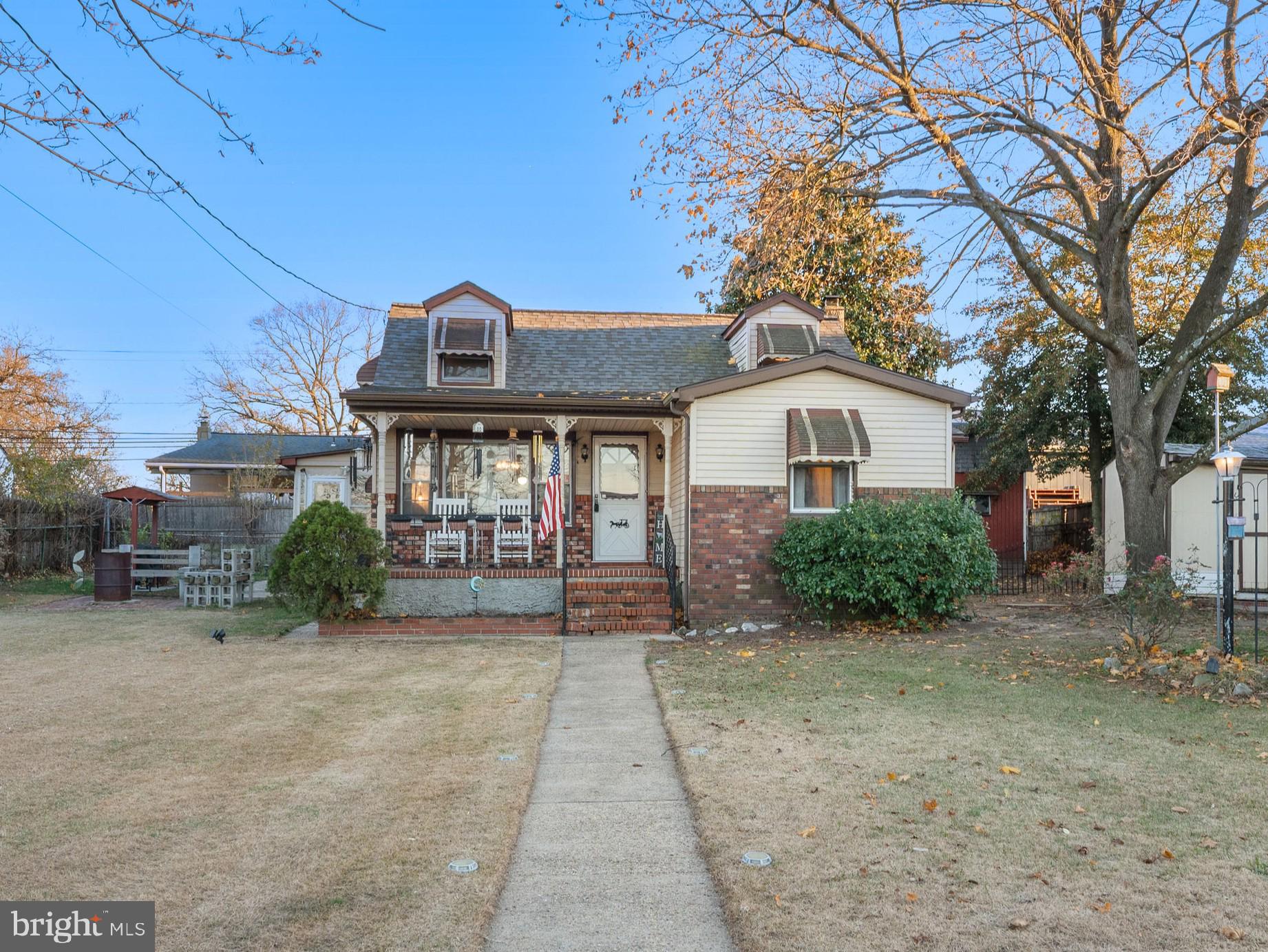 102 Queen Anne Road Glen Burnie, MD 21060 - Photo 2 of 26 a front view of a house with a garden