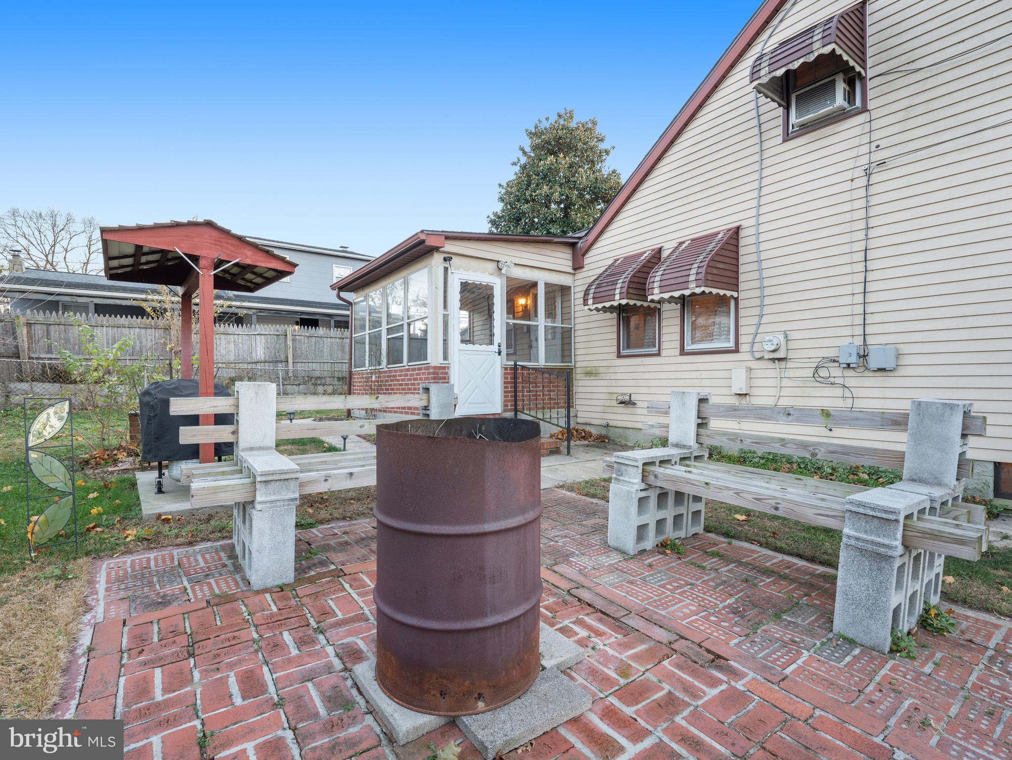 102 Queen Anne Road Glen Burnie, MD 21060 - Photo 22 of 26 a view of a patio with table and chairs and wooden fence