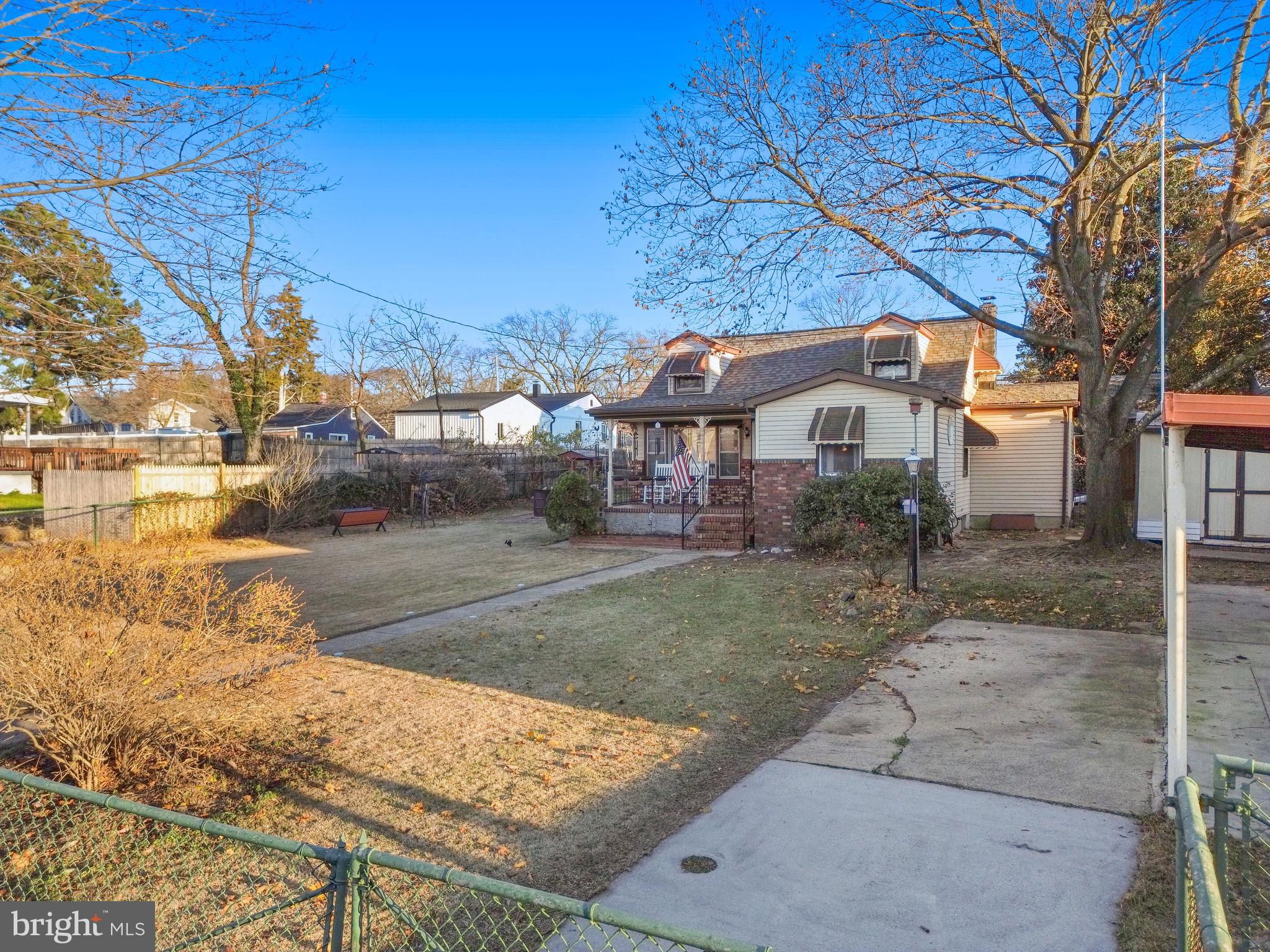 102 Queen Anne Road Glen Burnie, MD 21060 - Photo 24 of 26 a front view of a house with a yard