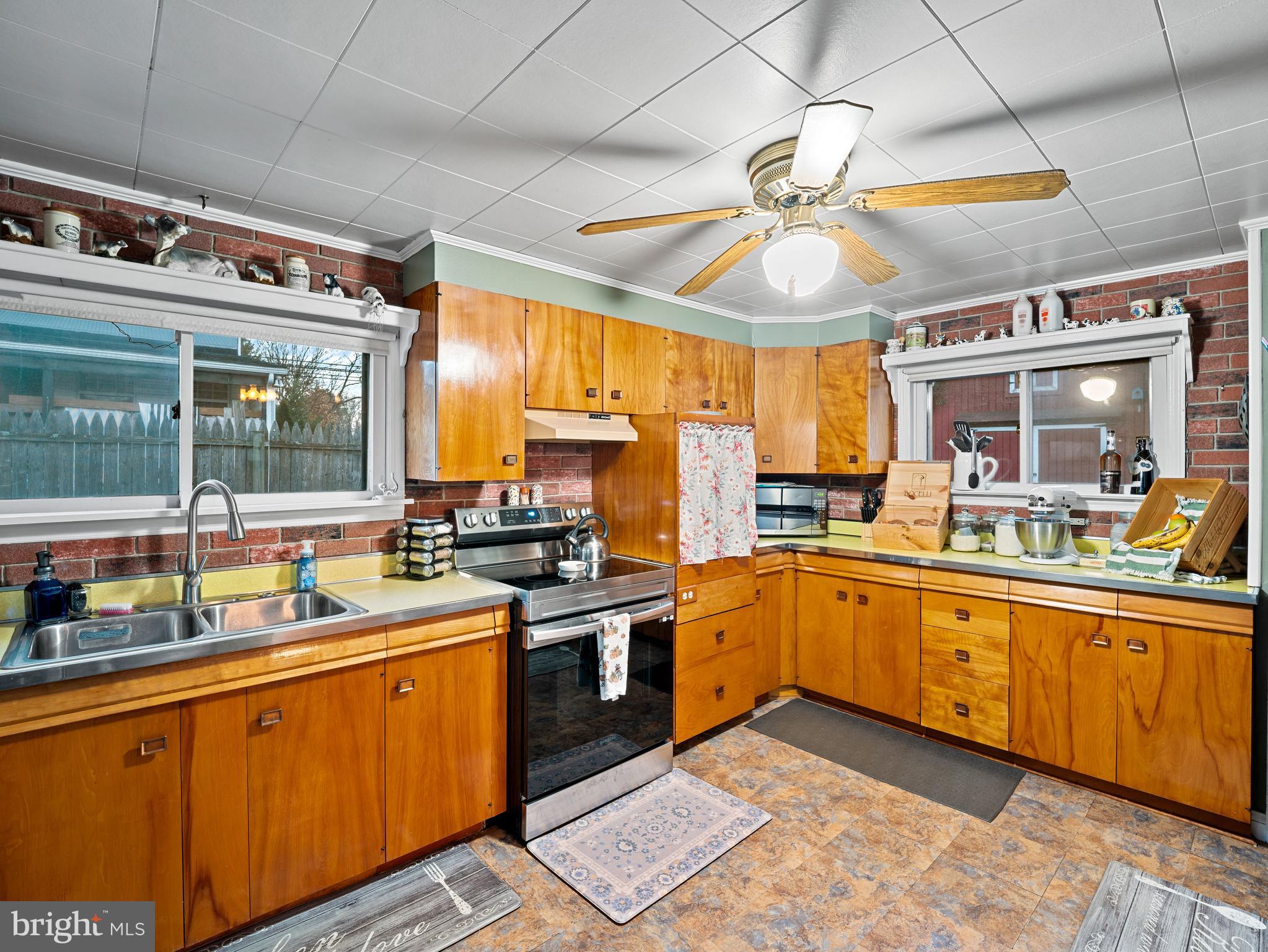 102 Queen Anne Road Glen Burnie, MD 21060 - Photo 8 of 26 a kitchen with stainless steel appliances granite countertop a sink and cabinets