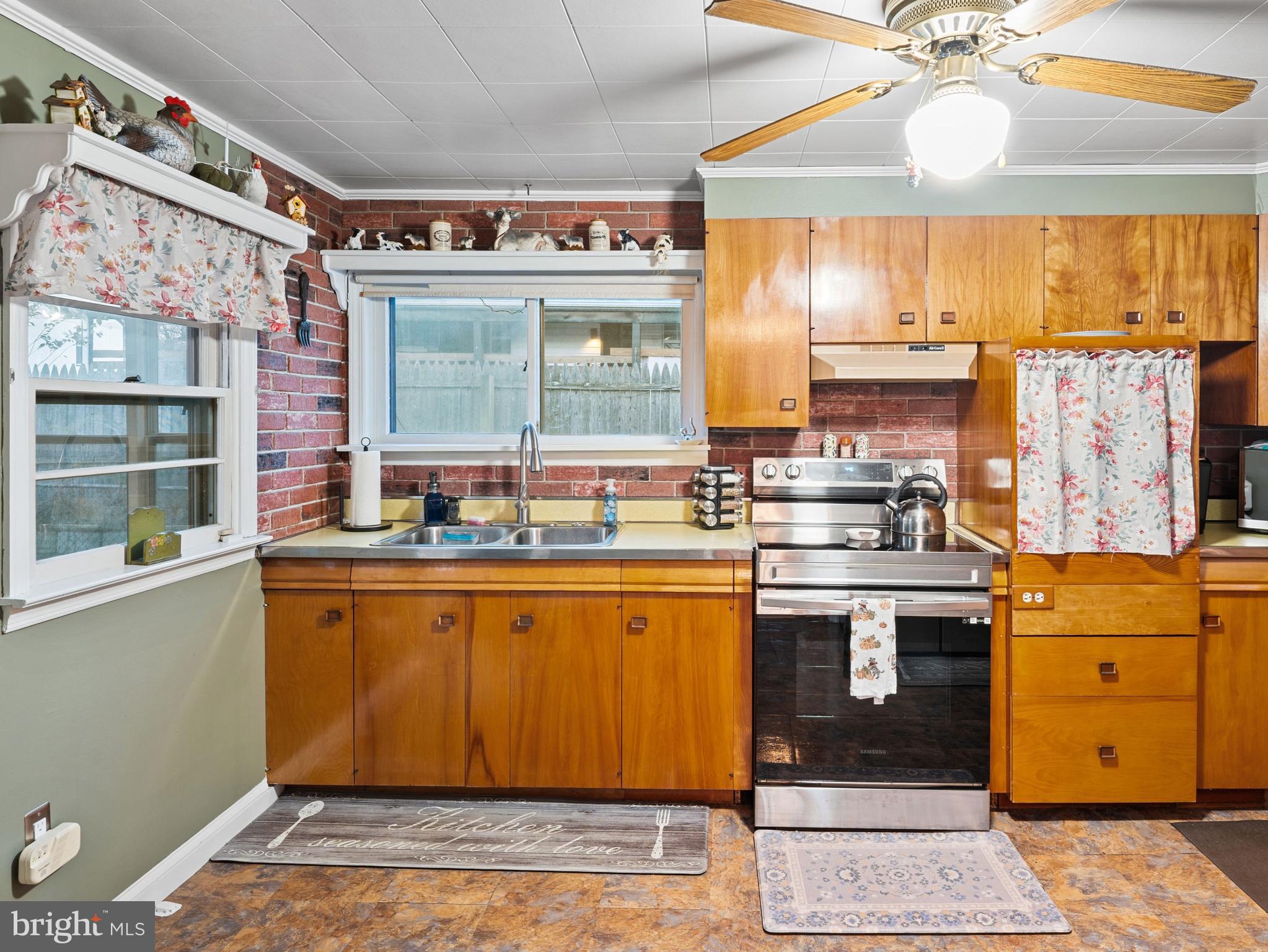 102 Queen Anne Road Glen Burnie, MD 21060 - Photo 10 of 26 a kitchen with stainless steel appliances granite countertop a stove a sink dishwasher and cabinets with wooden floor