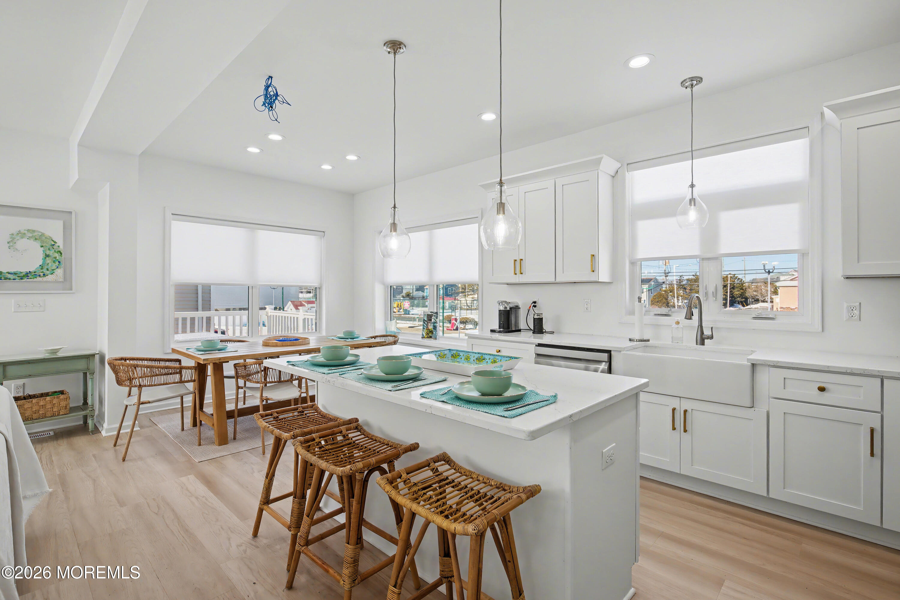 155 West Atlantic Way Lavallette, NJ 08735 - Photo 16 of 53 a kitchen with a dining table chairs wooden cabinets and white appliances