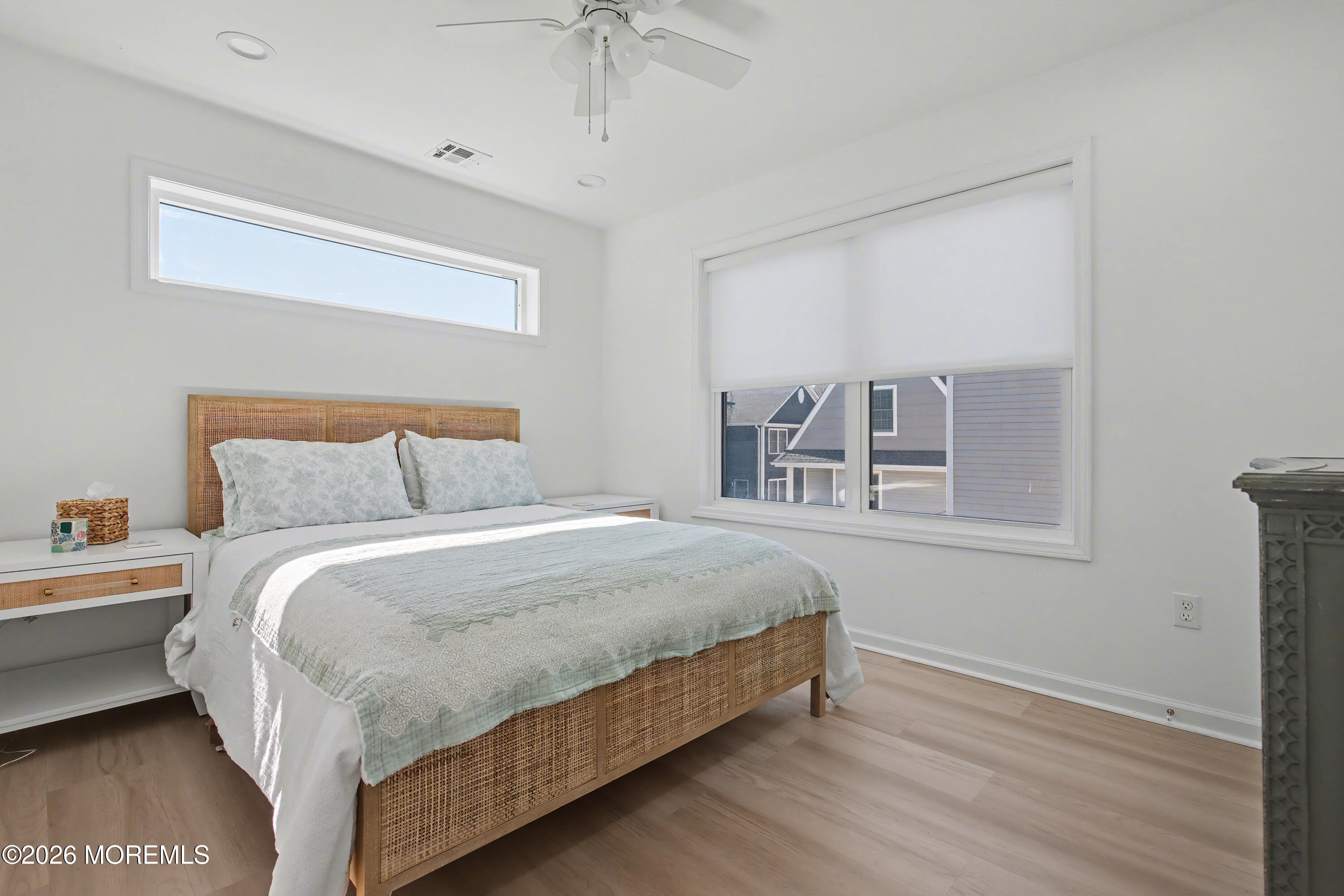155 West Atlantic Way Lavallette, NJ 08735 - Photo 30 of 53 a large bed sitting in a bedroom next to a window and a chandelier