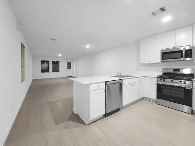 a kitchen with a refrigerator sink and stove