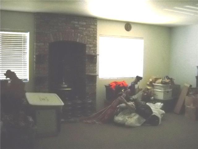 16063 Oakley Road Ramona, CA 92065 - Photo 6 of 13 family room is previous garage - large with pot belly stove