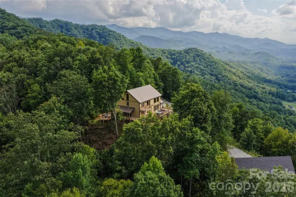 an aerial view of a house with a yard