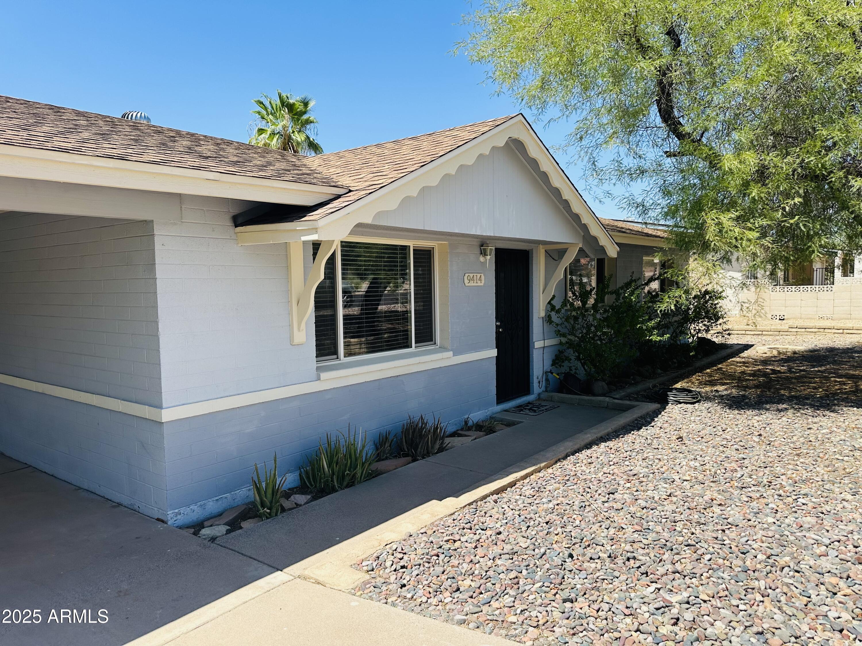 9414 North 17th Street Phoenix, AZ 85020 - Photo 1 of 19 a front view of a house with a yard