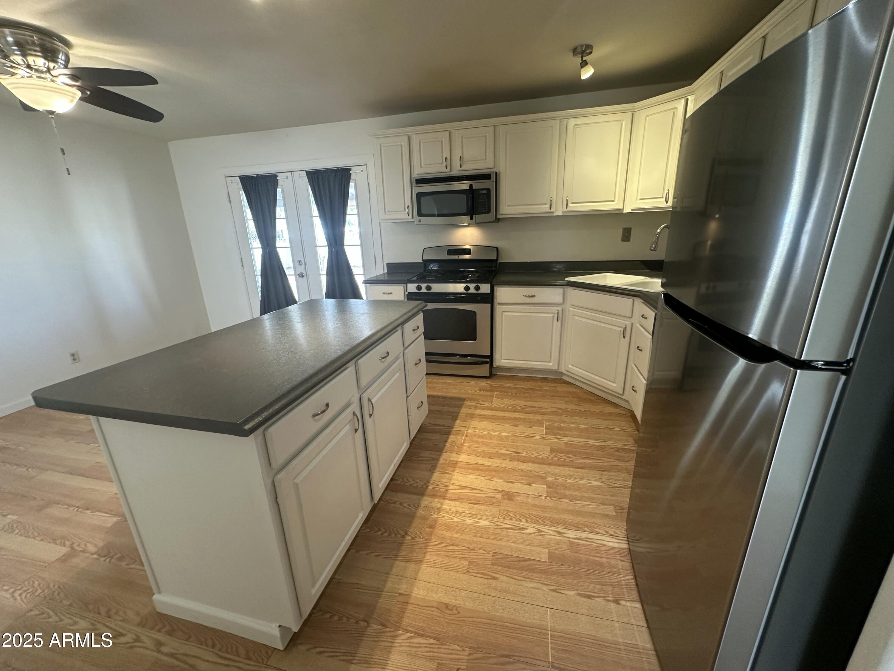 9414 North 17th Street Phoenix, AZ 85020 - Photo 7 of 19 a kitchen with stainless steel appliances granite countertop a refrigerator a stove a sink and a microwave