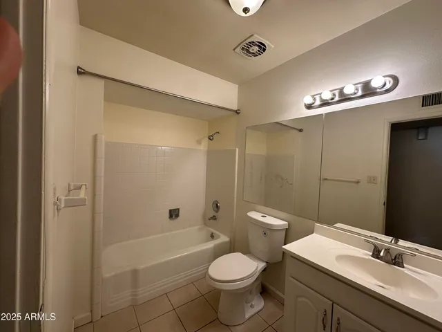 a bathroom with a toilet a sink and shower