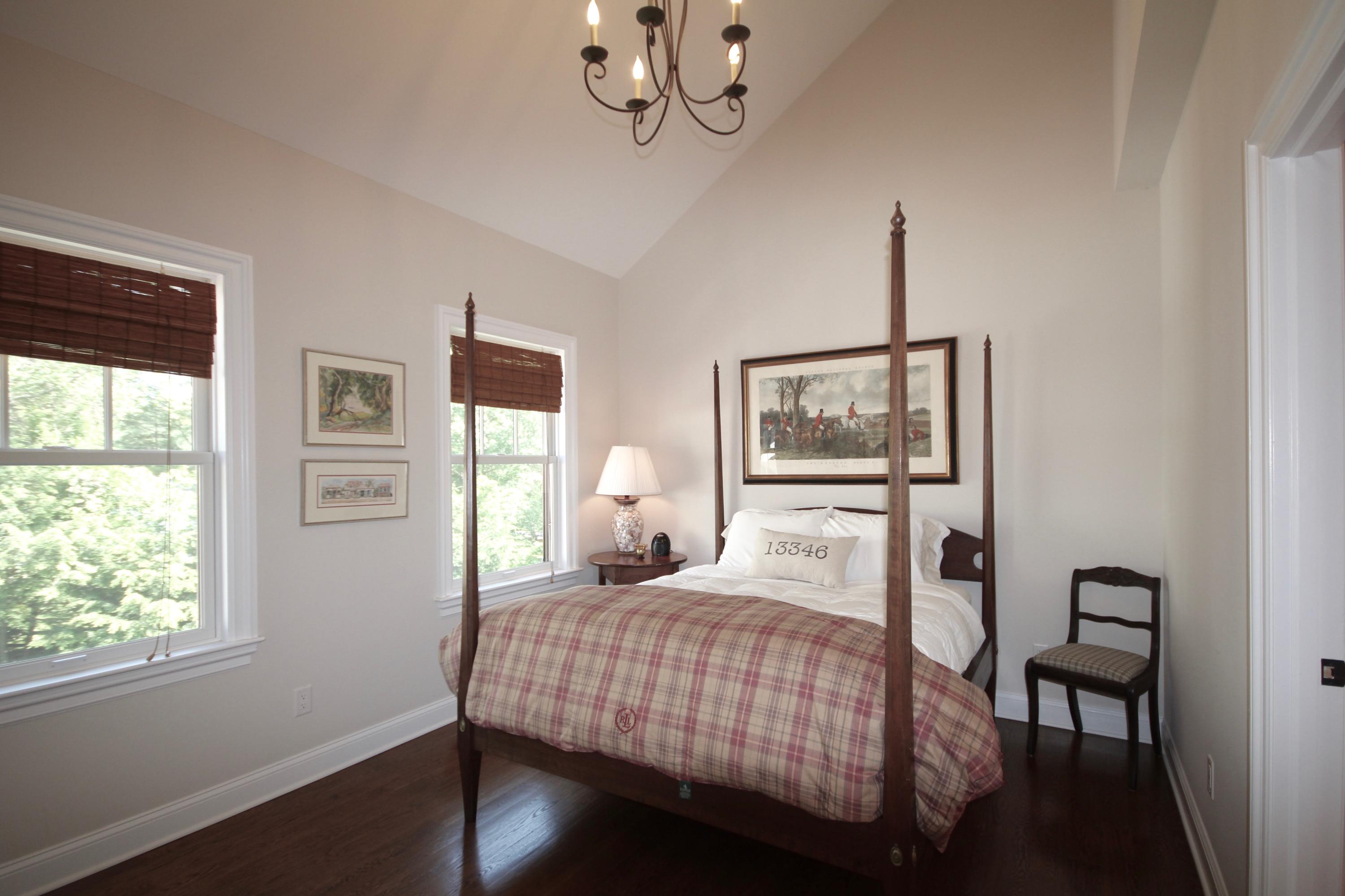 81 Parish Road New Canaan, CT 06840 - Photo 27 of 48 a bedroom with a bed and a chandelier