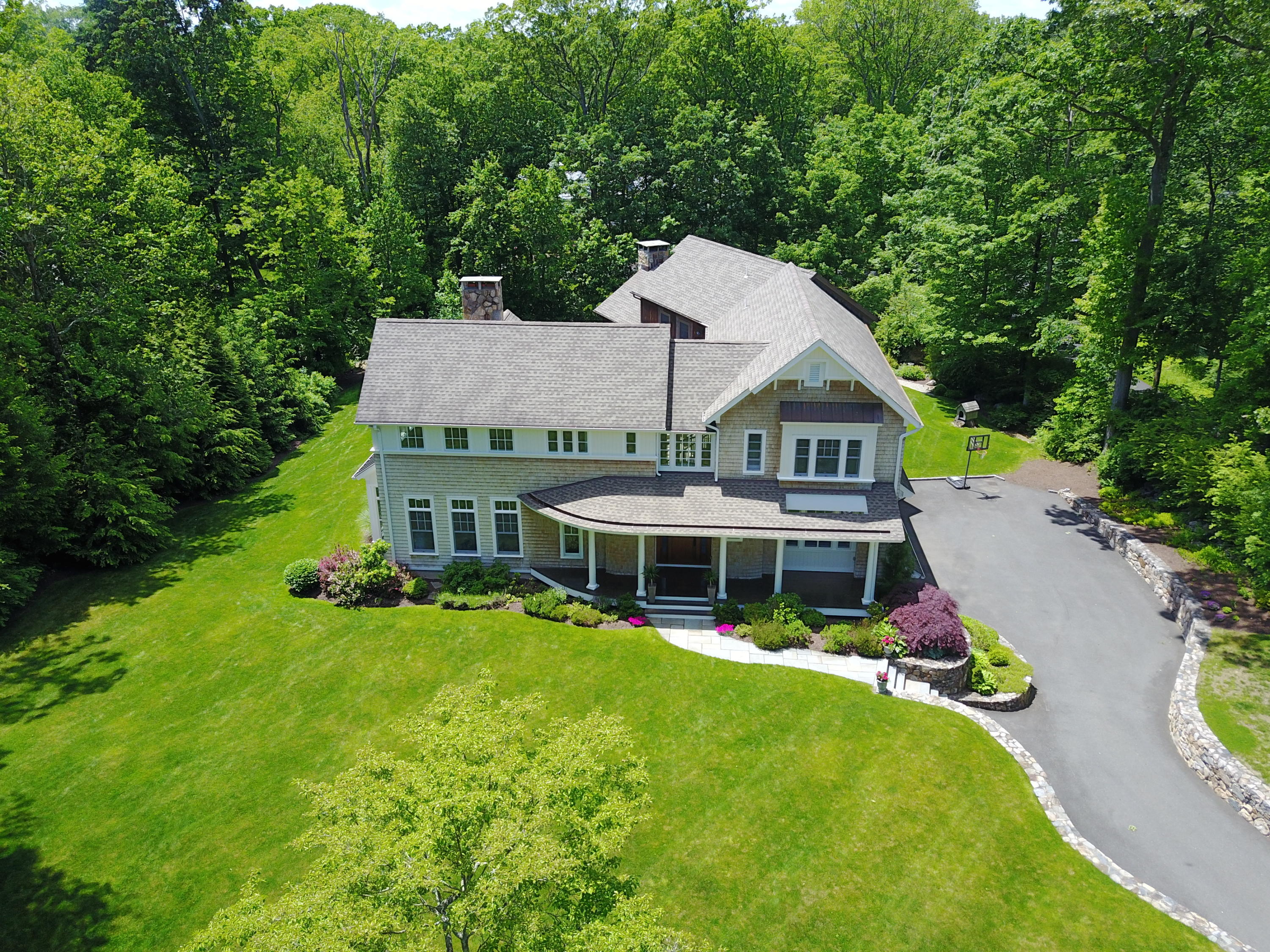 81 Parish Road New Canaan, CT 06840 - Photo 3 of 48 an aerial view of a house with swimming pool next to a big yard