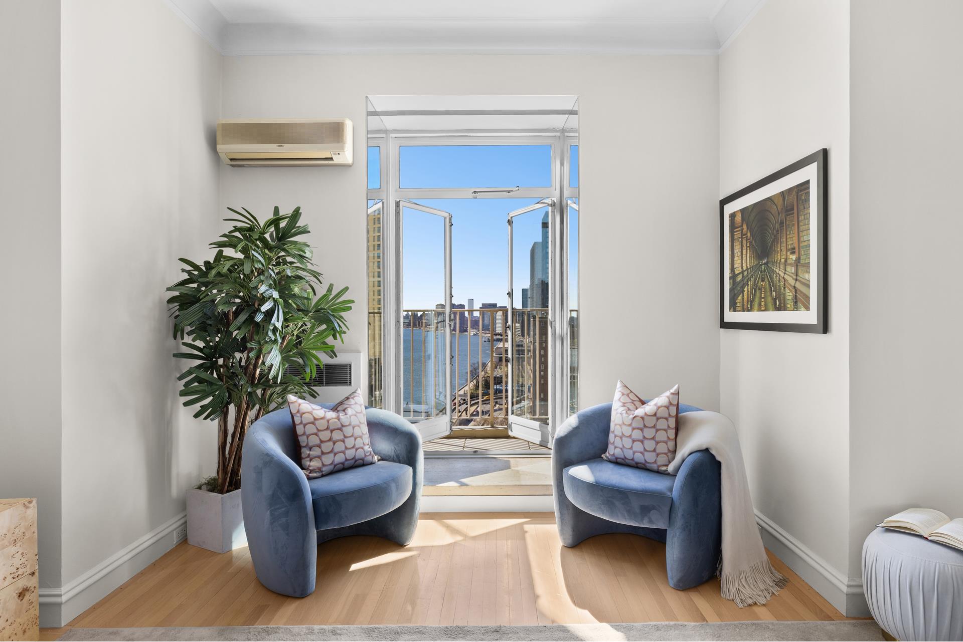 435 East 52nd Street, Unit 15A Manhattan, NY 10022 - Photo 11 of 17 a living room with furniture and a potted plant