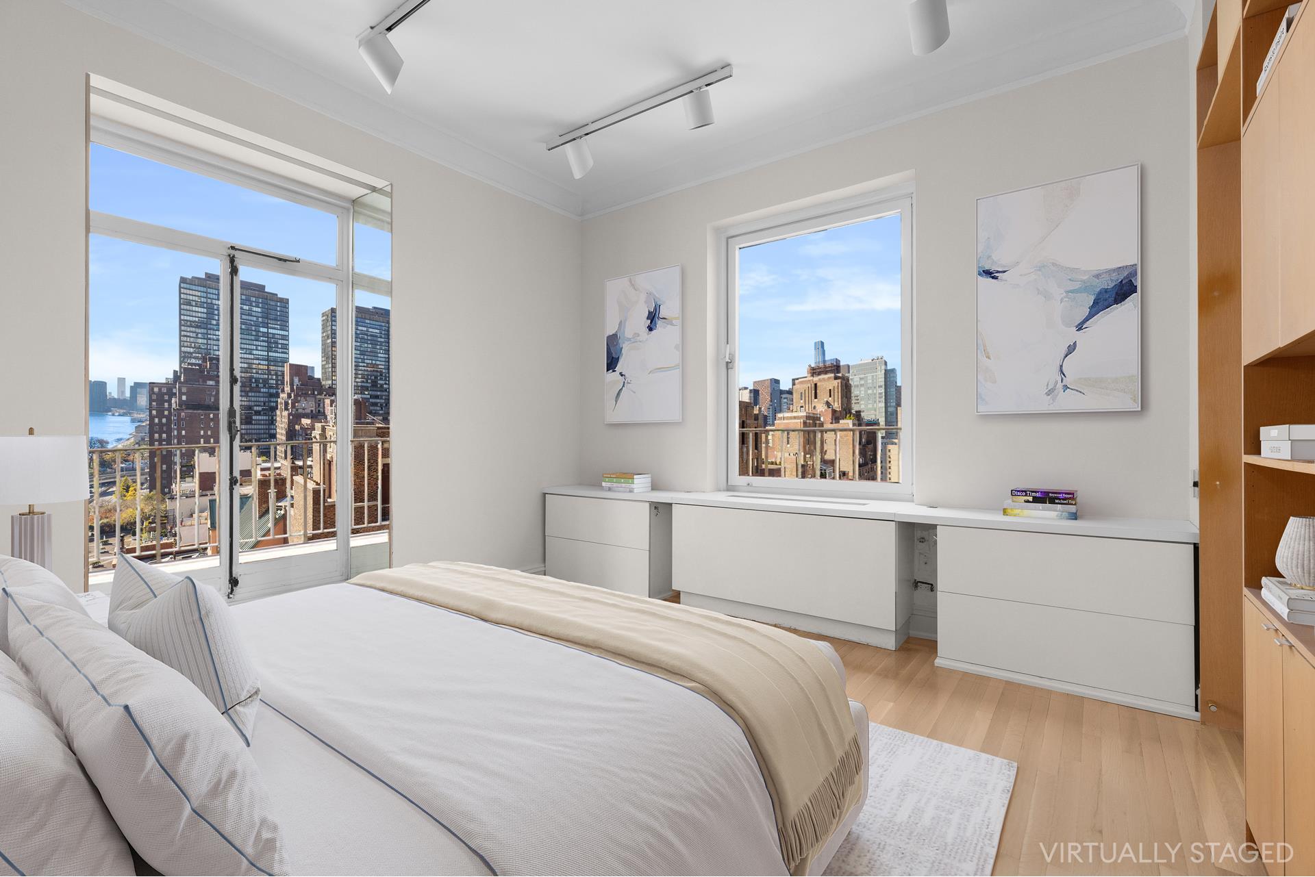 435 East 52nd Street, Unit 15A Manhattan, NY 10022 - Photo 13 of 17 a bedroom with a bed and a large window