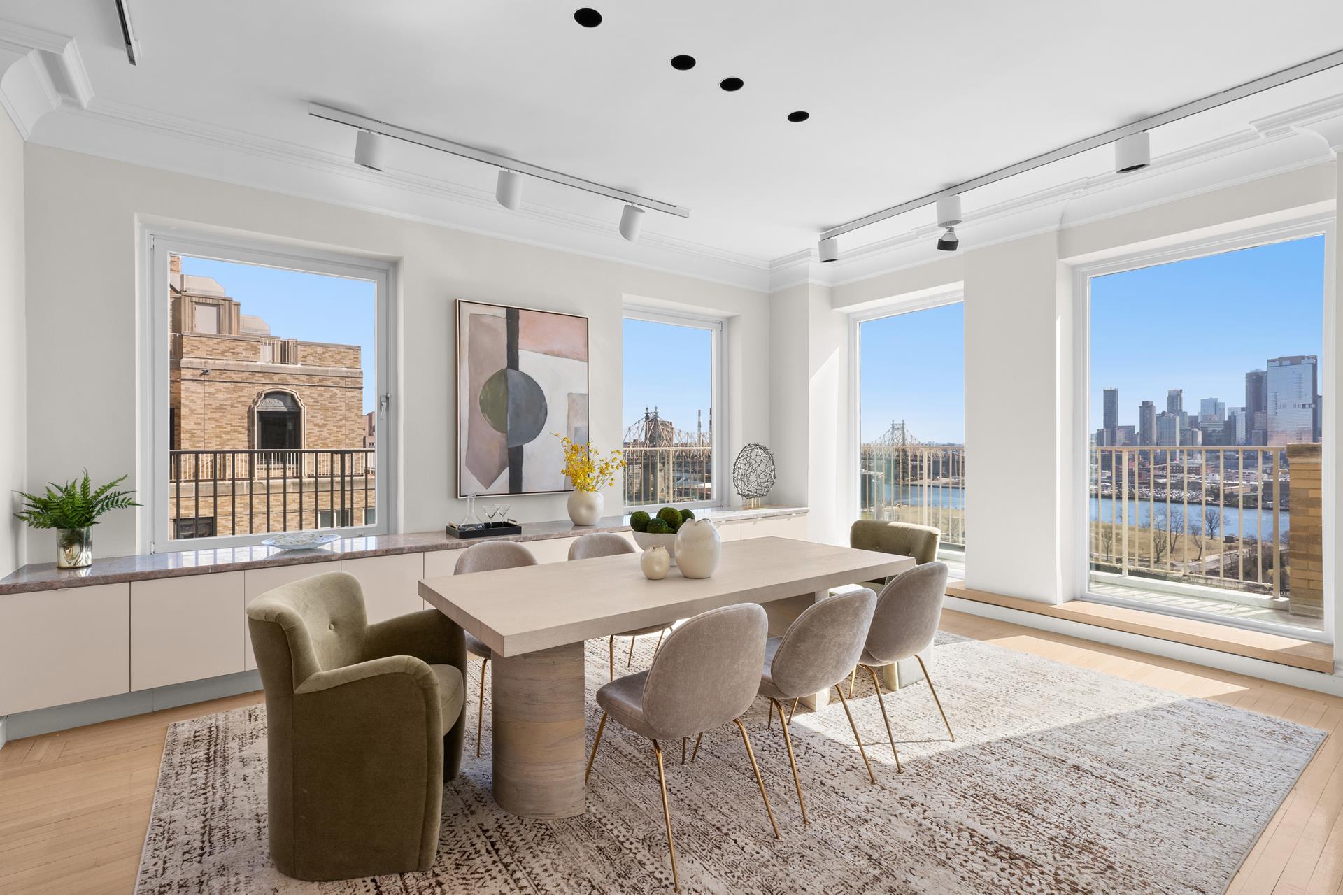 435 East 52nd Street, Unit 15A Manhattan, NY 10022 - Photo 3 of 17 a dining room with furniture a rug and a painting