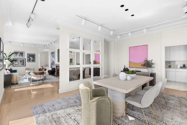 a dining room with furniture a rug and a painting