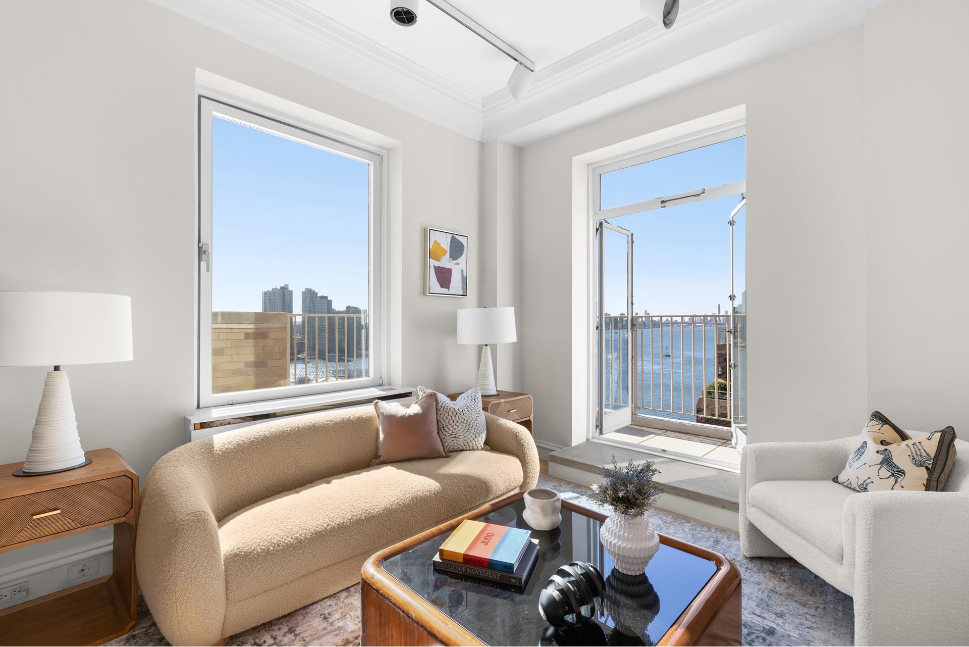 435 East 52nd Street, Unit 15A Manhattan, NY 10022 - Photo 5 of 17 a living room with furniture and a large window