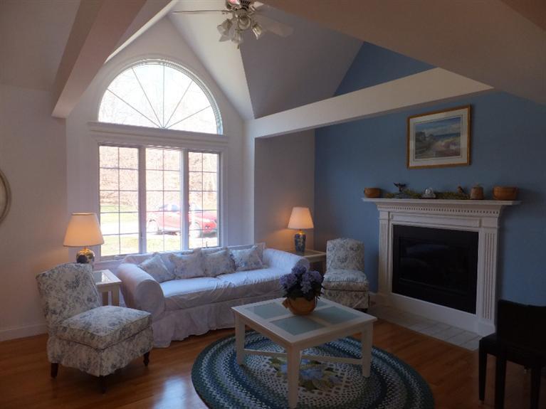 2179 Service Road West Barnstable, MA 02668 - Photo 4 of 26 a living room with furniture a fireplace and a large window