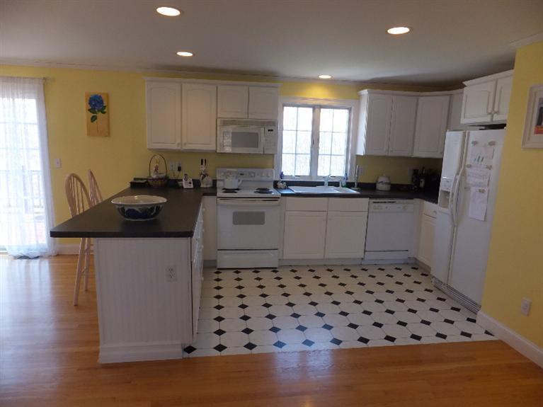 2179 Service Road West Barnstable, MA 02668 - Photo 8 of 26 a kitchen with granite countertop a sink a stove a refrigerator and cabinets