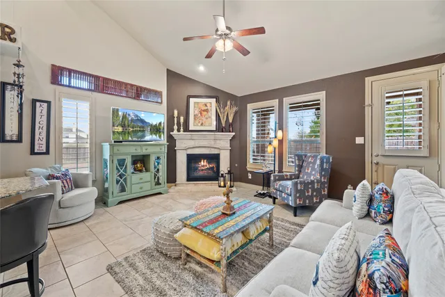 a living room with furniture fireplace and a table