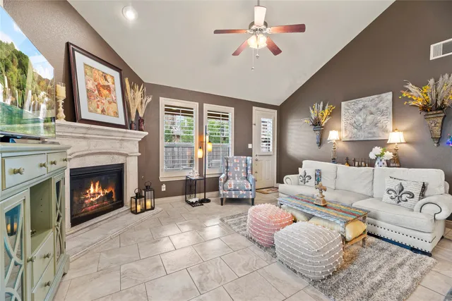 a living room with furniture a fireplace and a large window