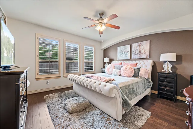 a bedroom with a large bed and a window