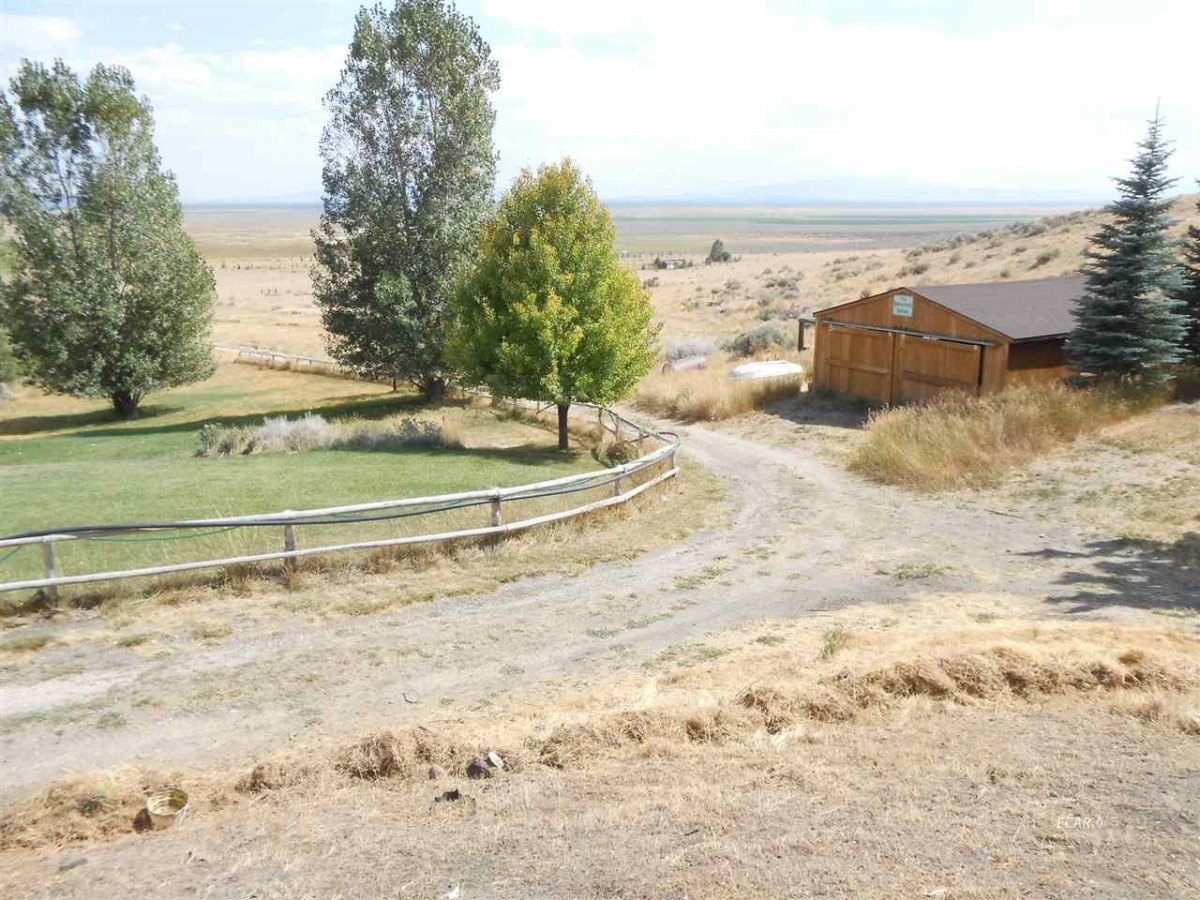 9039 Ruby Valley Road Spring Creek, NV 89815 - Photo 4 of 47 a view of a dry yard with wooden fence