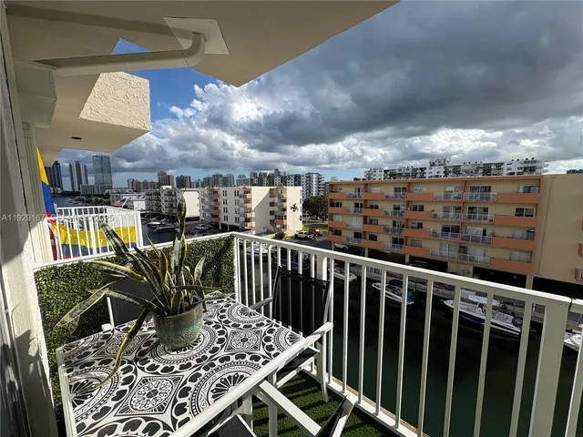 a view of a balcony dining table and chairs