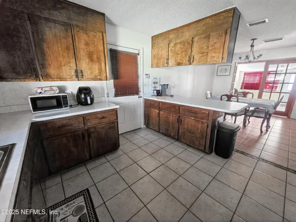 a kitchen with a sink a stove and cabinets