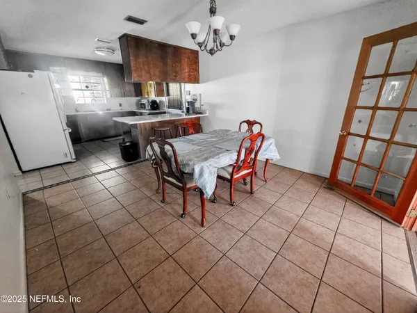 a dining room with furniture and window