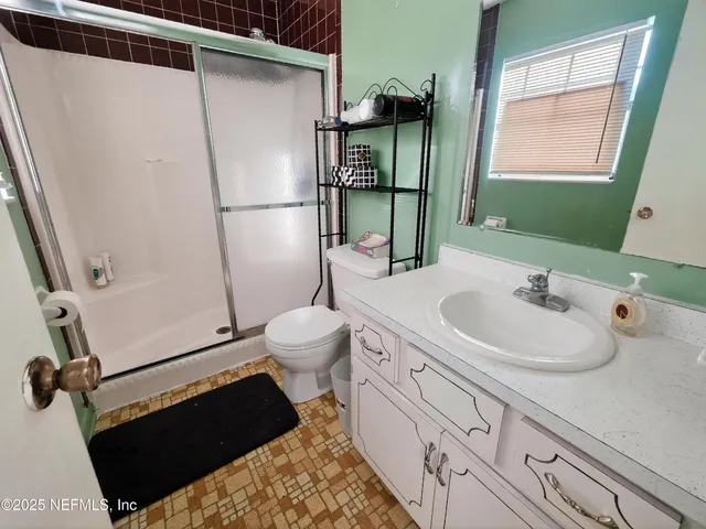 a bathroom with a sink toilet and shower