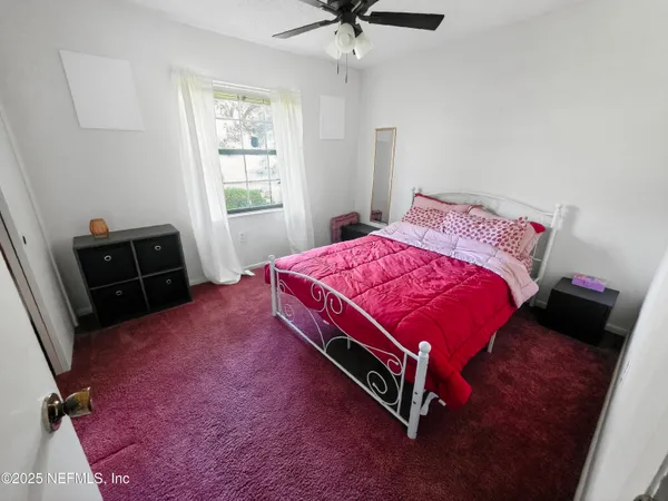 a bed room with a bed and a window