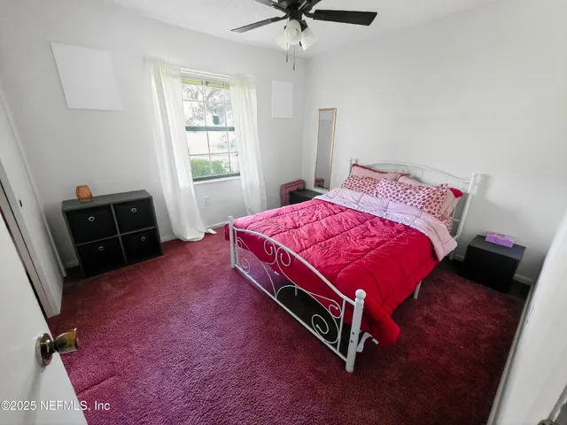 a bed room with a bed and a window