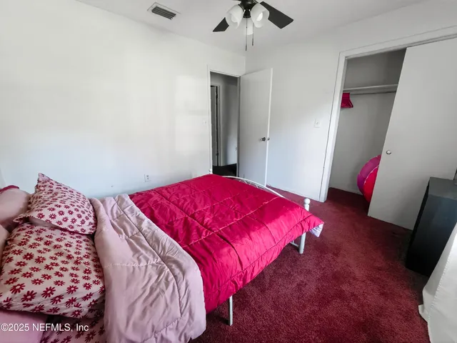 a bedroom with a bed and a chair