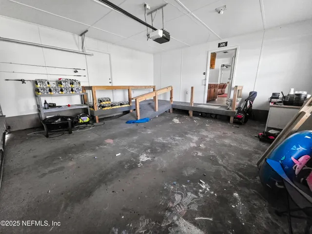 a living room with lots of furniture and clutter