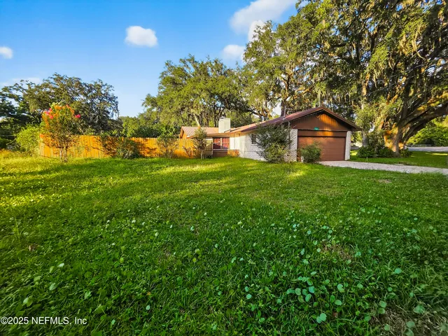 a view of yard with swimming pool and green space