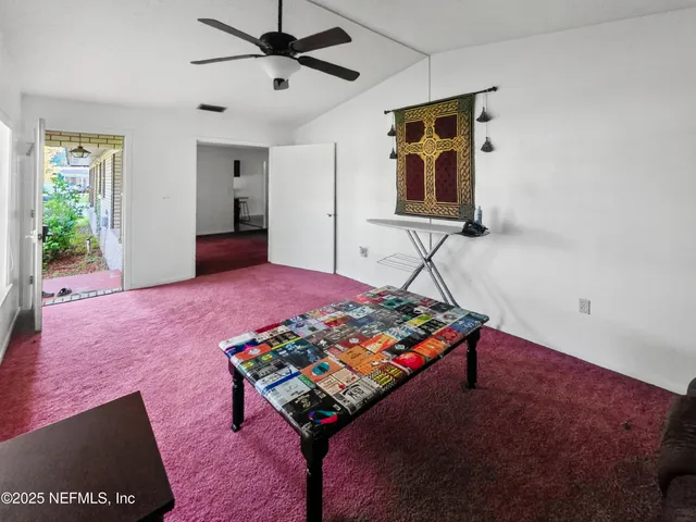 a bedroom that has a bed and a table in it