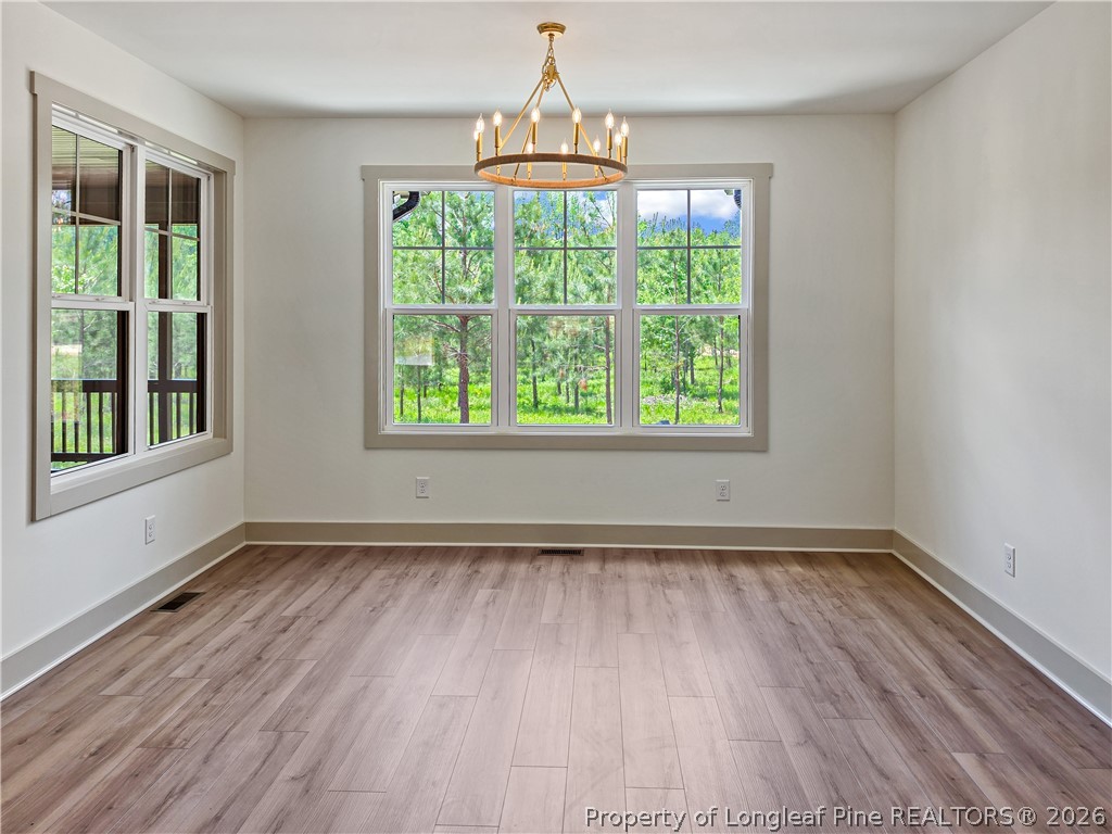 900 Niagara Carthage Road Carthage, NC 28327 - Photo 6 of 38 a view of an empty room with wooden floor and a window