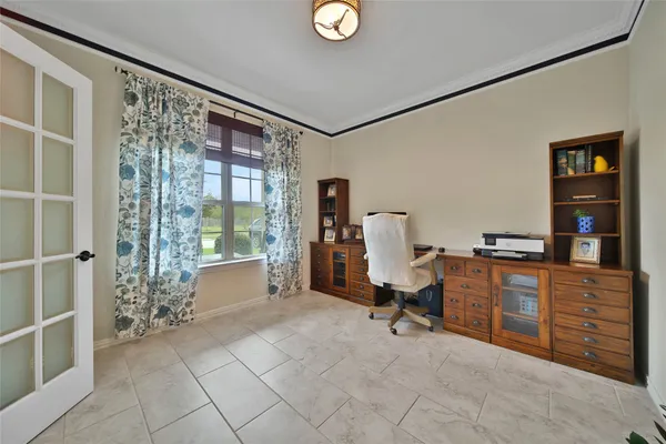 a bedroom with furniture and a large window