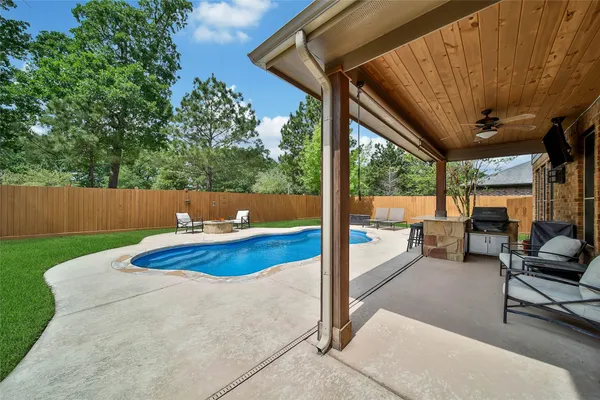 a bedroom with a bed window and a chandelier