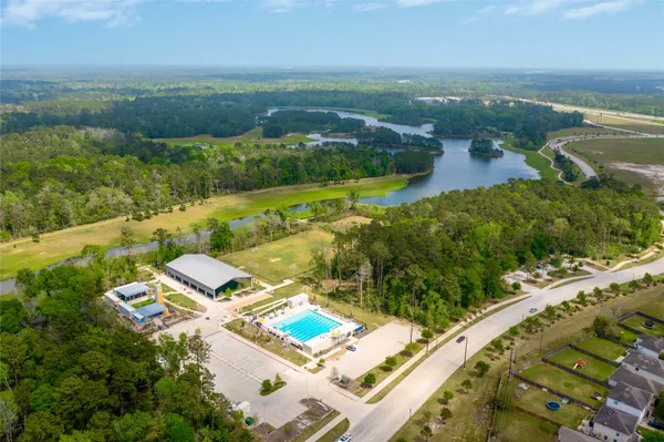 an aerial view of residential houses with outdoor space and river