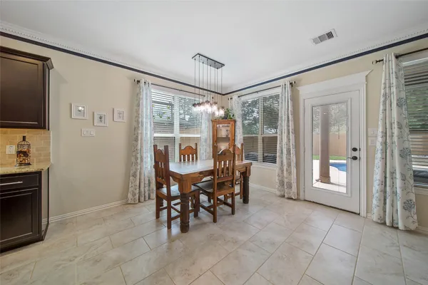 a dining room with furniture and window