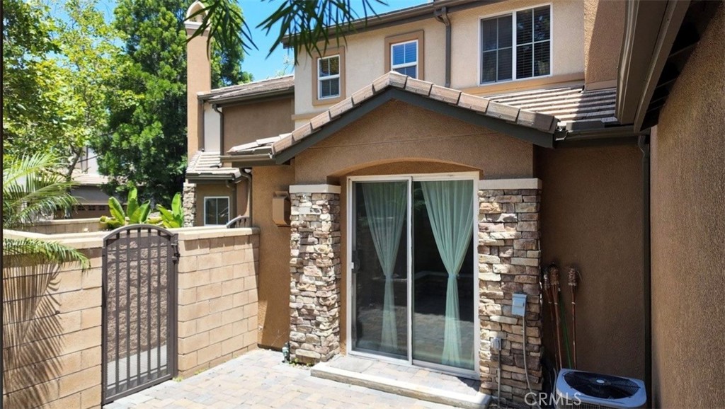 8692 East 9th Street, Unit 56 Rancho Cucamonga, CA 91730 - Photo 24 of 34 a front view of a house with a yard