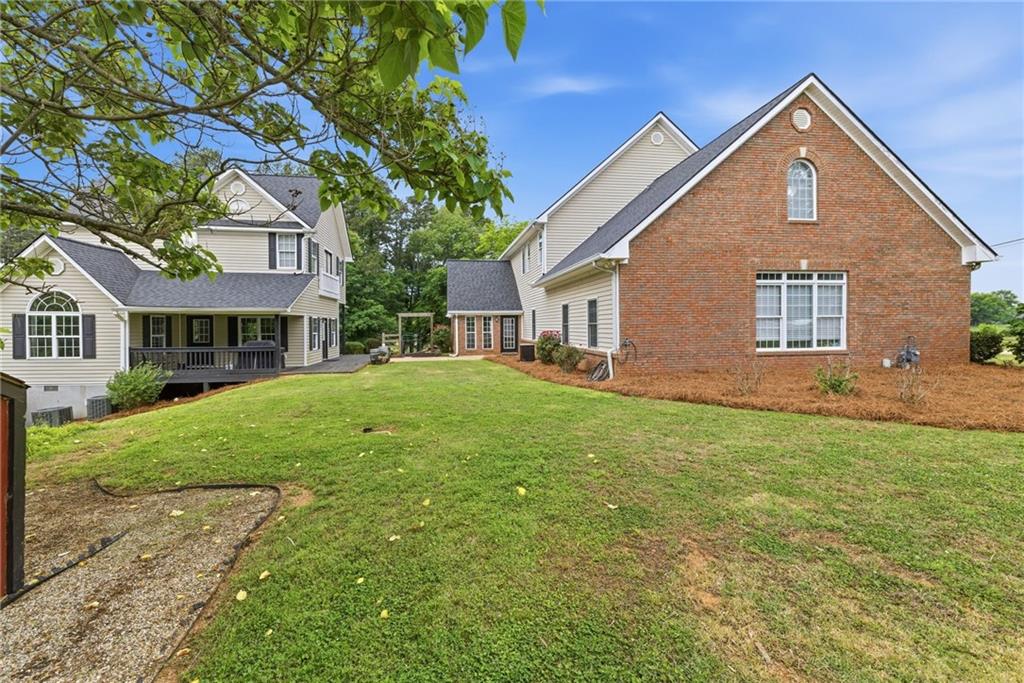 4337 Mountain View Road Oakwood, GA 30566 - Photo 67 of 84 a front view of a house with a yard and trees
