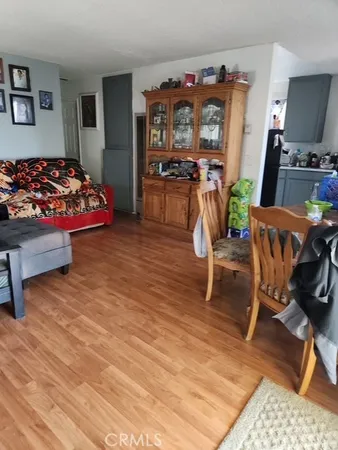 a bedroom with furniture and a wooden floor