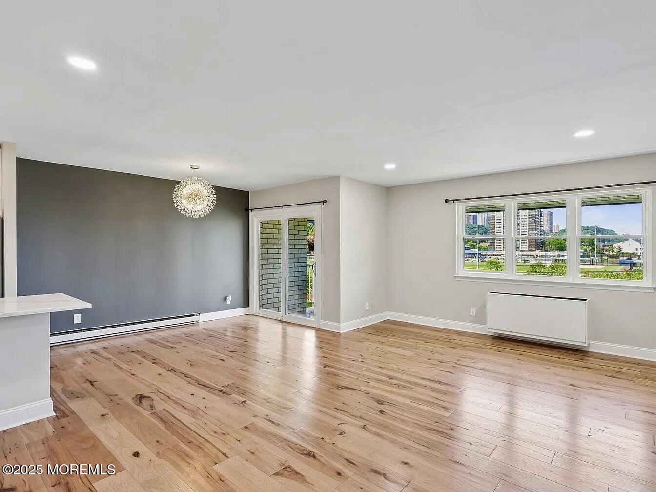 1111 River Road, Unit H20 Edgewater, NJ 07020 - Photo 2 of 14 a view of an empty room with a window and wooden floor