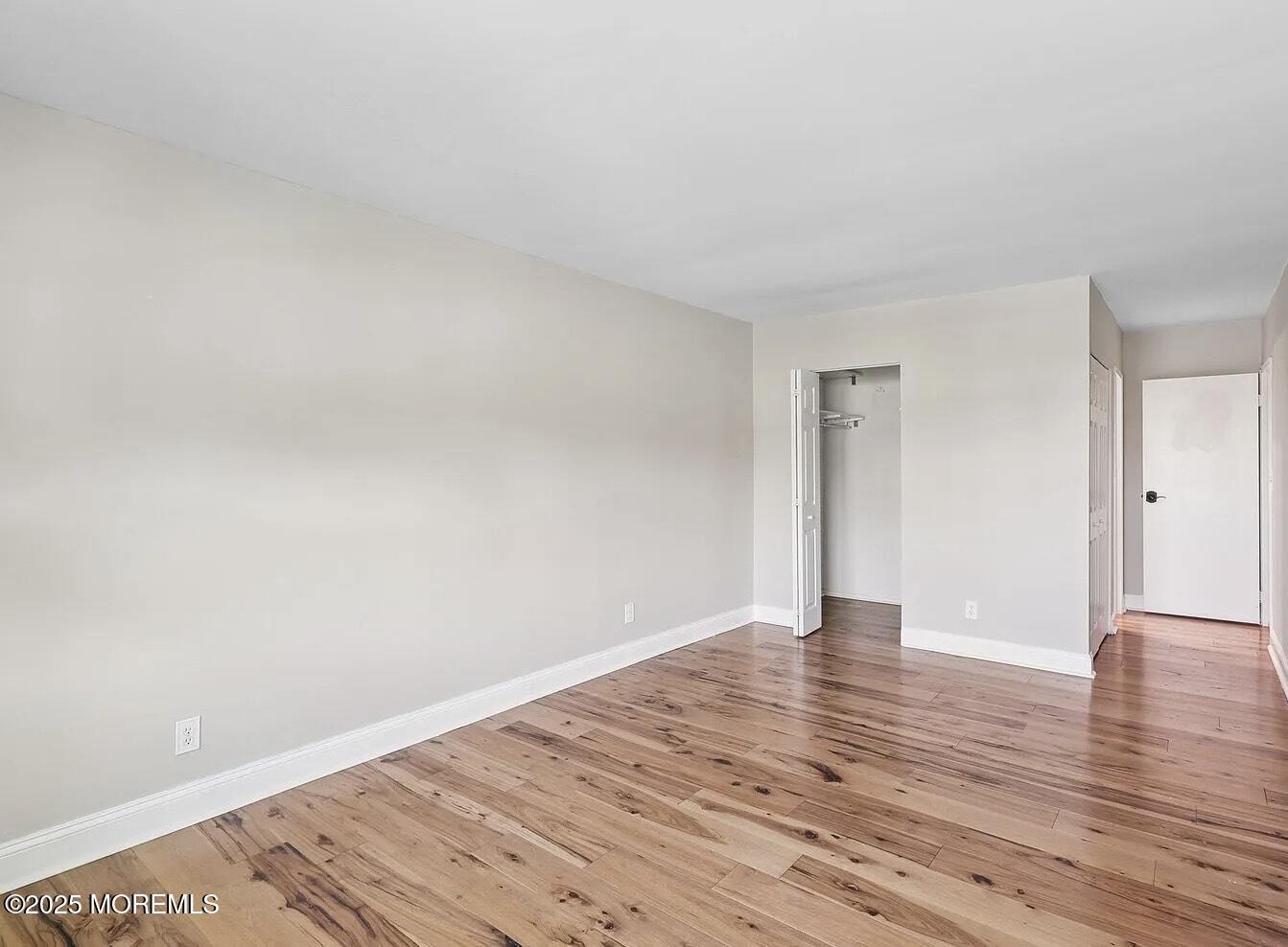 1111 River Road, Unit H20 Edgewater, NJ 07020 - Photo 5 of 14 a view of an empty room and wooden floor